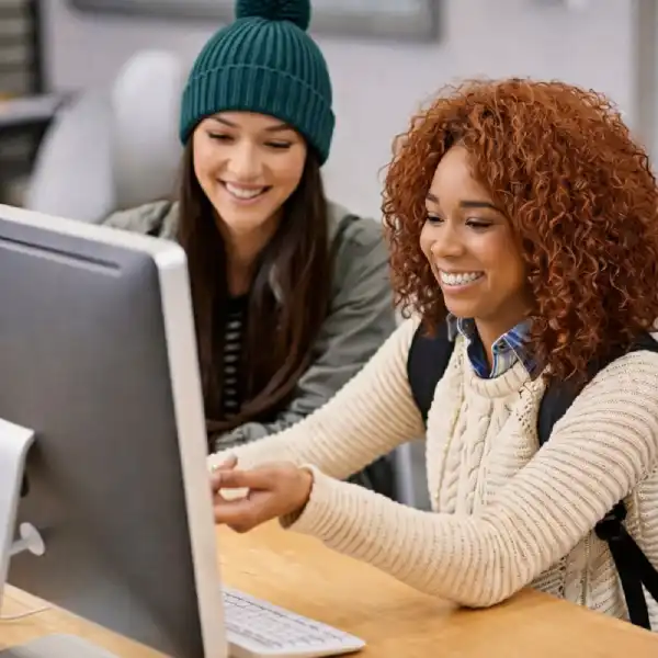 Two learners working together at a computer in a collaborative learning environment