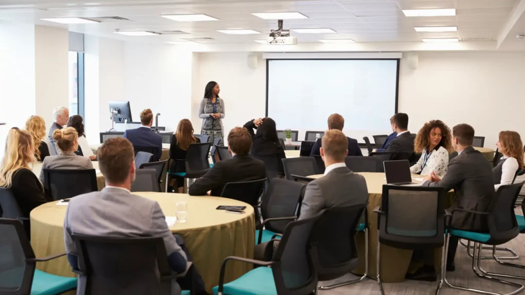 Facilitator presenting to a group of professionals during a corporate training session