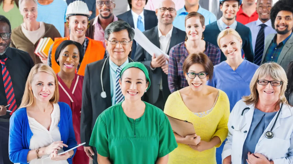 Diverse group of professionals from multiple industries standing together and smiling