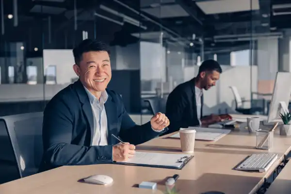 Business professional collaborating in a modern office environment, representing workplace-ready business skills.