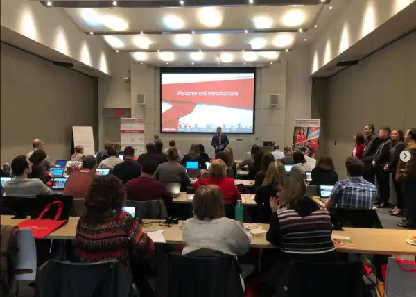 Instructor presenting to a classroom audience during a professional training session.