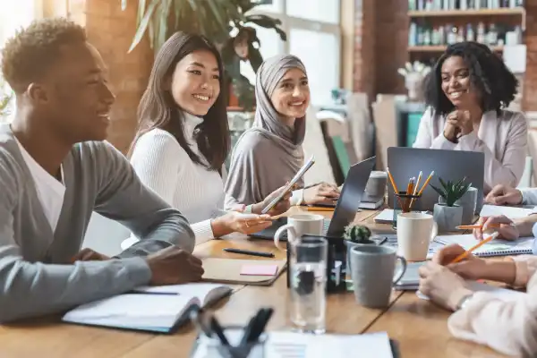 Diverse group of professionals collaborating in a meeting environment.